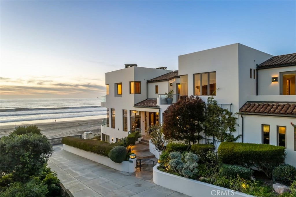 Quite simply one of the best combinations of Strand location, orientation and home ever built on the Strand. Located on arguably the best corner lot on the Strand, this spectacular, custom-built home features a commitment to quality and attention to detail that literally set the bar for Strand elegance. Custom built by David Garinger at over $700/sq ft (in 2001 dollars), this home features 5 bedrooms, 5.5 bathrooms in over 5,300sf, 5 car garage parking (including two vaulted spaces) plus room for 2 more vehicles on the apron, and an open floor plan that functions beautifully while maximizing natural light and world class ocean views.  Enjoy, an often not contemplated, perfect buffer from downtown, which translates into a short stroll to dinner, but far enough to avoid congestion. With the rare, sought after southern exposure of a north corner lot, the home is designed around capturing the most prized, signature views on the Strand: the Manhattan Beach Pier, PV Peninsula and Catalina Island. You won’t just entertain your guests, you will dazzle them.

One of the other cherished amenities of living in Manhattan Beach is its convenient lifestyle. One doesn’t need to leave “The Bubble” of our little beach community 95% of the time. However, if you wish to fly anywhere in the world, LAX International Airport is 5 miles north.  Living on the beach, on the edge of the continent, our culture revolves around the ocean and beach lifestyle. It's active, friendly and fun, yet laid back and relaxed all at once. Our roots are steeped in beach volleyball, water sports like surfing and paddle boarding, exercising along the Strand and gatherings enjoying the same. We have wonderful, sacred traditions like the Manhattan Beach Open, which is beach volleyball’s "Wimbledon," the Fourth of July, the Sixman V-Ball Tourney, International Surf Festival, MB Grand Prix Cycling races, Old Hometown Fair, Concerts in the Park, the Holiday fireworks show, and so much more. Manhattan Beach is truly one of the best places to live on the planet. Mild temperate weather year round ranging from mid 40’s to mid 80’s, but living in the 50’s to 70’s most of the time. This beach city has something for everyone. Whether you are looking to find a friend, raise a family, have a weekend get-a-way or retire here, the combination of weather, convenience and lifestyle is unmatched. You collect rarities, now live in one.