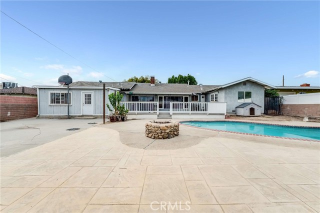 Beautiful back yard with pool, Basketball court, and firepit