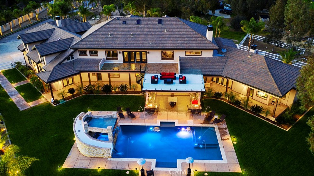39625 Calle Cabernet Temecula, California One of Temecula Wine Country's most distinguished luxury estates is now on the market! From its private gated entry to its beautiful panoramic views this estate is one of a kind. The home features almost 8500 square foot of open living space with 7 bedrooms, 9 bathrooms, 6 car garage and an attached guest house with a bedroom, bathroom, full kitchen and living room and even its own laundry room. The interior of this estate is full of upgrades including a beautiful wrought iron staircase, crown molding, tile and laminate wood floor, bathrooms in almost every room, walk in closets, a gourmet kitchen with a built in fridge, thermador appliances and even two dishwashers. The exterior of the home has so much to offer, its an entertainers paradise with its outdoor kitchen equipped with granite counters a pizza oven, bbq, beverage refrigerators, ice maker, warming drawers, and even a dishwasher. All of this is overlooking the beautiful view and your very own pool with water features, a waterfall, grotto and a slide. The garage is the perfect area to store all your toys and can also make a great workshop, it has 6 parking spots plus rv pull through and its own bathroom. The home is really a must see as it has so much to offer that we just cant list it all!