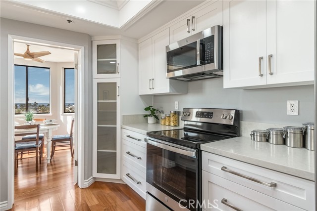 Beautifully remodeled kitchen with new stainless appliances, quartz counters, soft close cabinets and big ocean views