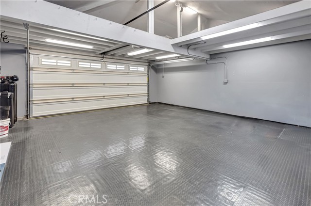 2 car oversized finished garage with lots of storage, water softener and tankless water heater.