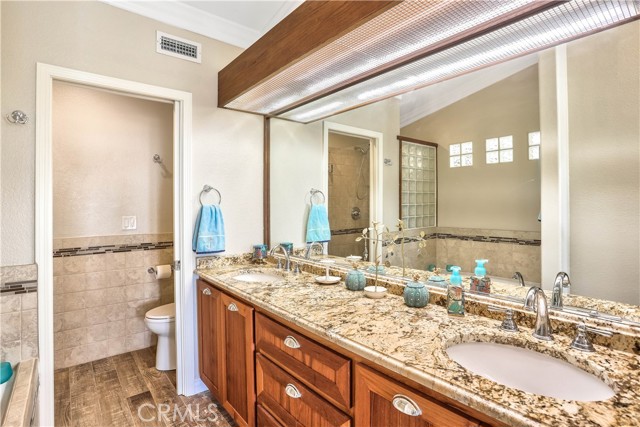 The ensuite master bathroom is upgraded with dual sinks, vanity and flooring.