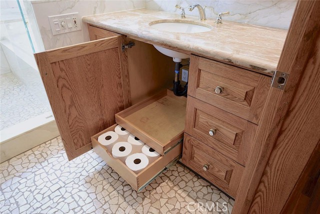 Red-oak cabinetry with pull-out drawers; under-sink electrical outlet