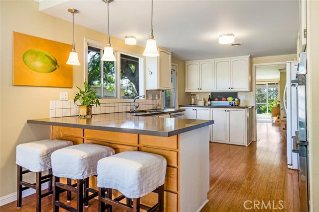 Hardwood flooring continues in the kitchen with beautiful stone countertops.