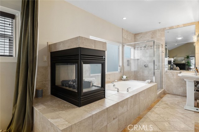 Functional and rejuvenating...spa tub, step-in shower, dual pedestal sinks, glowing fireplace...all within your private suite.