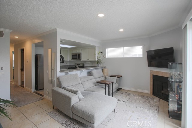 Bright living room with recess lighting and fireplace