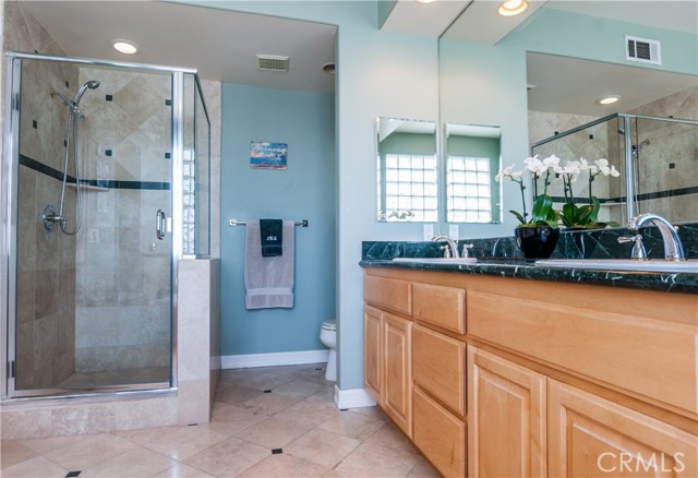 Glass-enclosed shower of private master bath.