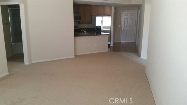 Currently has carpeting over hardwood flooring.