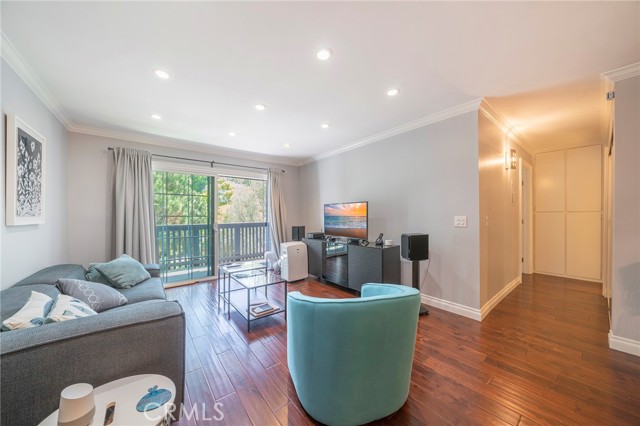 Comfortable living room with sliding door and in window air conditioning.