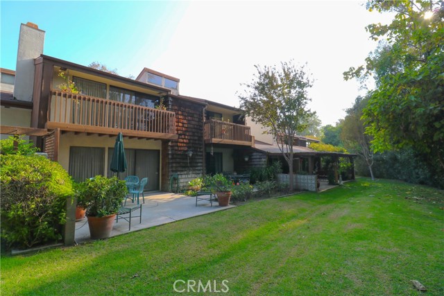 Backyard of unit, including two patio areas.