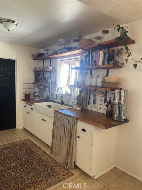 Subway tiled kitchen backsplash with butcher bock countertops.