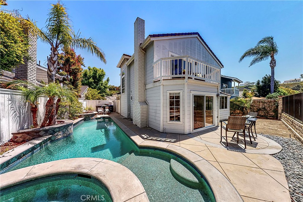 Located in Beacon Hill — one of Laguna Niguel’s premier neighborhoods —  this stunning 3 bed, 2.5 bath home is loaded w/ pizzaz! It delivers livability & high style w/ soaring ceilings, open living spaces & an array of windows that light the interior from every angle. Beautiful wood floors are warmed by sunlight, contrasting w/ crisp white & gray finishes that give this home its distinctive coastal feel. Skylights in the 2nd story illuminate the entry & formal living area. The sunny galley kitchen is a cheerful place for preparing your favorite meals, w/ fresh white cabinets & granite countertops. Grow your own herbs in the garden window. A sunroom window extends into the vaulted ceiling & provides a welcoming backdrop for the breakfast nook. An artisan brick fireplace is the focal point of the spacious family room, which opens to the back patio/pool. Retreat to your private oasis w/ plenty of room for entertaining & a custom pool/spa that showcases water features & lush landscaping. The property is bordered by green belt in the rear, enhancing seclusion & quiet. Gated side yard is ideal for pets. From your private master suite balcony, enjoy the tranquility of your yard & views of the surrounding hills. You’ll also love the vaulted ceilings, large walk-in closet & luxurious bath w/ dual vanities & soaking tub. Home is strategically positioned behind the 2-car garage & away from the street for extra privacy. Beacon Hill offers many amenities, including pools & tennis courts.