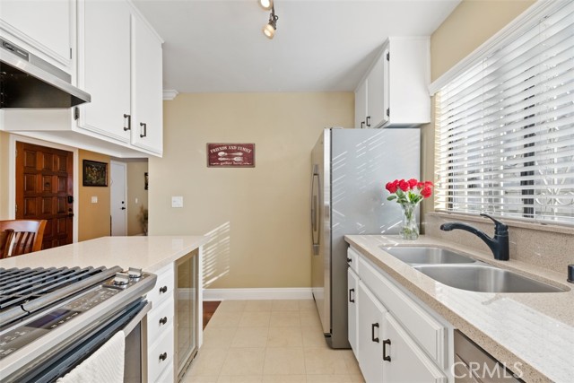 Well appointed kitchen with stainless steel appliances and quartz countertops