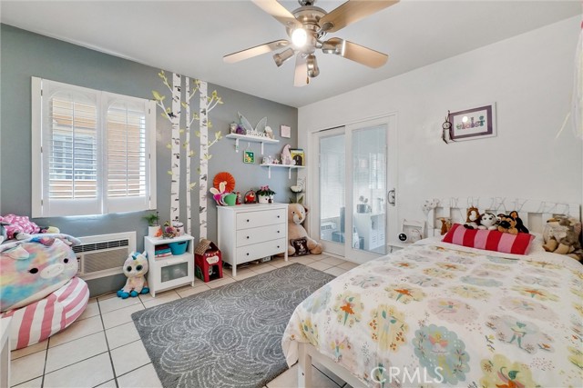 Bedroom 2. Upgraded Dual vinyl windows, plantation shutters, ceiling fan