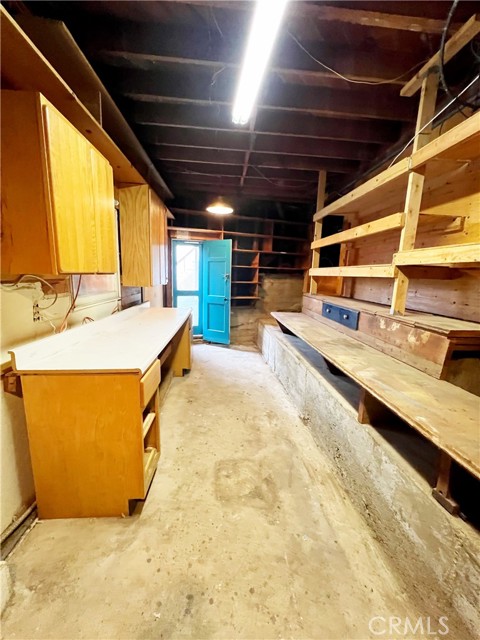 Workshop and storage area with separate entrance tucked underneath the main level at rear of property