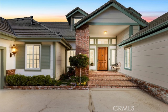 Isn't this just beautiful? Let's walk up the brick steps, open this custom door, and go inside and take a peek!