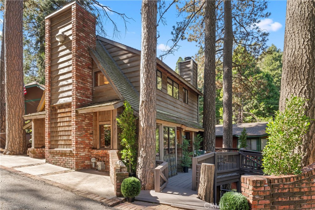 Charming and One of a Kind Unique Cabin Located On One of Lake Arrowhead Villas most Desireable Cul de Sac Streets. This Quintessential Cabin Retreat is On Market for First Time in Decades. A Large Level Parking Deck that Bridges Directly to Level Entry Couldn't Make It Easier for Entry and Access with Multiple Car Parking.  Mountain Ambiance Exudes With Large Wood Burning Used Brick Fireplace and Hearth, T & G Paneling, Raised Height Ceilings, Built In Book Case, Window Seating Open to Spacious Kitchen with Tons of Counter Space, Precious Nooks & Cranny's Throughout that Warm Your Heart and Soul Embrace the Nostalgic Character. A Full Bath is on Main. The Unique and Well Designed Staircase Up Takes You Into a Large Loft Area and Master Suite Retreat Featuring Vaulted Ceilings, Sitting Area, Fireplace, another Full Bath and Again- More Great Storage Spaces. On Lower Level, Another Flexible Second Bedroom, Large Enough to Be Self Contained for Secondary Living and Multiple Sleeping Areas, All in One! A Quarter Bath Has Room for Potential Shower in Closet area. Walk Out to the Multiple Decks Next to a Babbling Stream With Catwalk To Huge Enclosed Workshop or Kids Play Space Complete With Doors and Windows, Framed In For Your Imagination's Use. Modifications Over Decades of Time Have Been Completed That Add Free Flowing Utility Large Enough For Even Multiple Families. Years Of Great Memories and Stories Are Reminiscent Of Once Upon A Time. Even Trails Down to Lake Arrowhead Village Have Been Hiked and Pride of Ownership Is In the Surrounding Homes. Excellent Positioning To Get In & Out to Lake, Village, Shops & Dining with Santa's Village, Skypark and Skiing Minutes Away Up St. Hwy. 18. Walk to the Famed Tudor House for Sunday Brunch Where Bugsy Malone is Storied to Visit. One of the Most Creative Fun and Exciting Cabin's We've Seen In This Enclave Of Arrowhead Villa Homes.  Property Is Being Sold As Is Condition* with Staged Furnishings Not Included but Available Through Jeannine's Interiors at Lake Arrowhead Village On a Separate Basis. This is a Trust Sale and Subject to Trustee Approval Which Will Be An Easy Process.