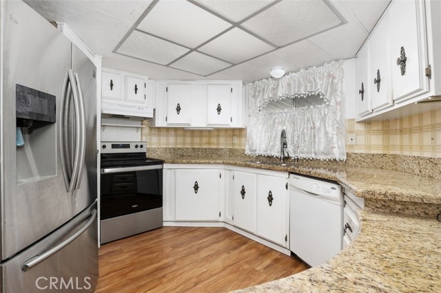 Updated kitchen features abundant cabinetry and granite countertops.