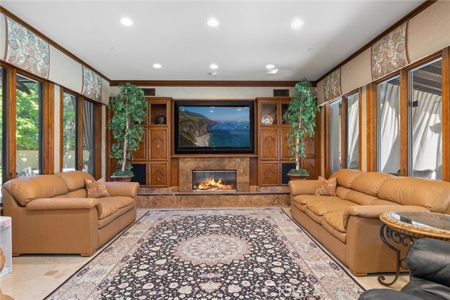 Family room with fireplace and lots of windows.
