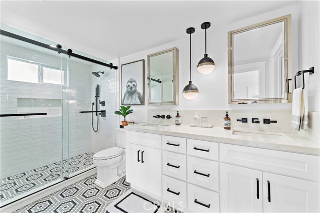 Dual sink, dual shower head bathroom located upstairs off Primary Bedroom.