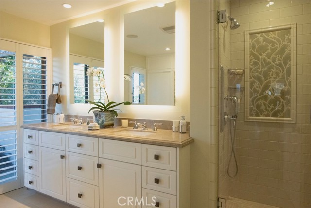 Lighted Mirrors and Double Sinks and a Large Shower