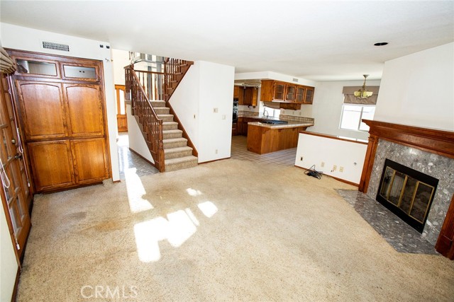 Family Room: Fireplace, storage and French Doors to side patio