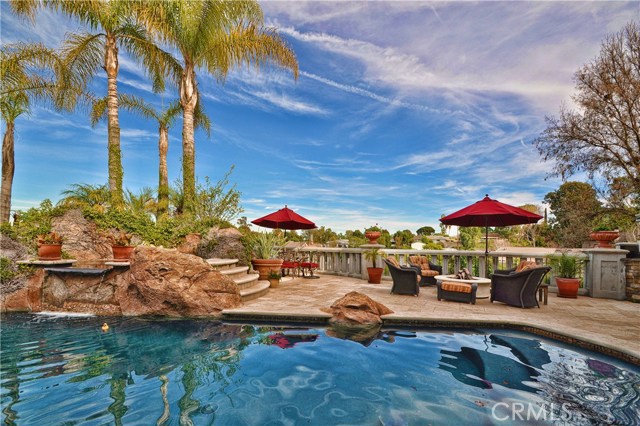 Pool waterfall and fire pit lounge area