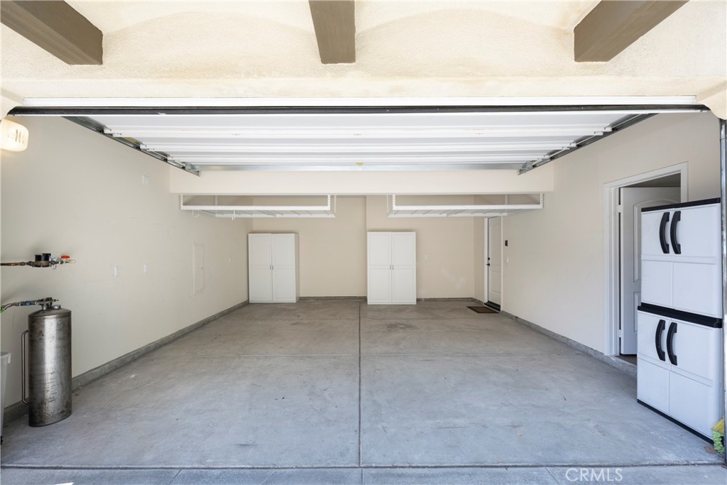 Large 2 Car Attached Garage with Direct Access to the Home! The Garage is fully finished with Built-in Cabinetry, Wire Overhead Storage Racks, and Garage Door Opener!