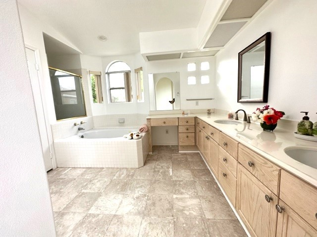 Primary bathroom include a double sink with lots of cabinets.