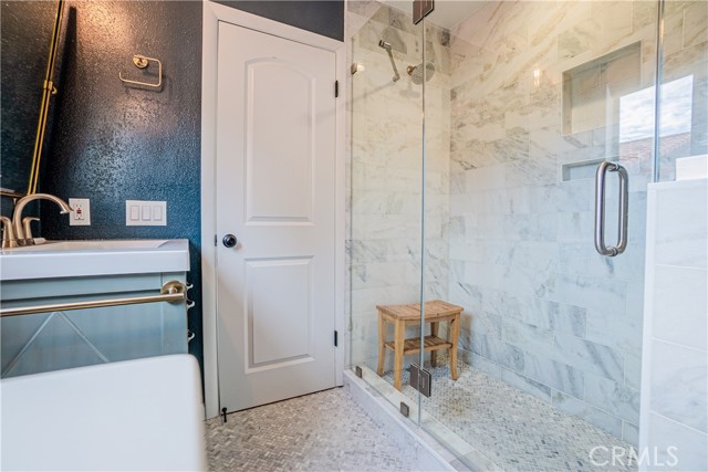 The beautifully styled ensuite bathroom with dual sinks and large spa-like shower.