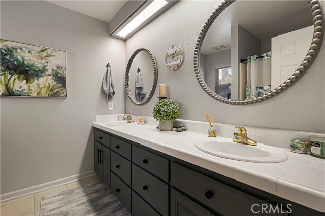 Primary ensuite with double sinks, upgraded mirrors, cabinet handles and designer paint!