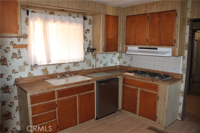 Kitchen window, sink, range top cabinets