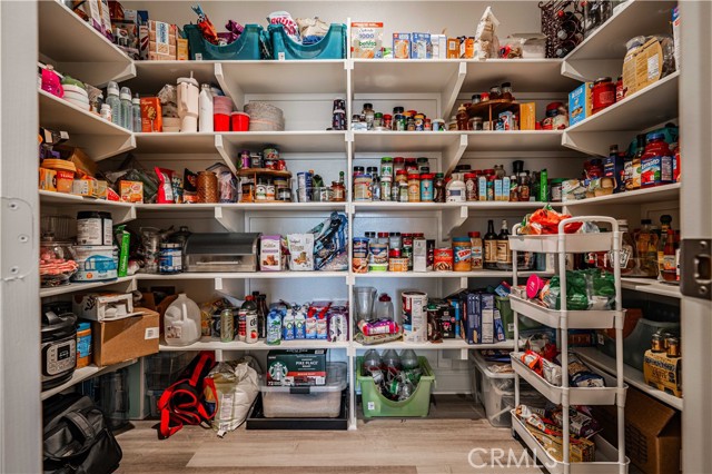 Walk-in pantry is oversized! Wood laminate flooring in here as well.