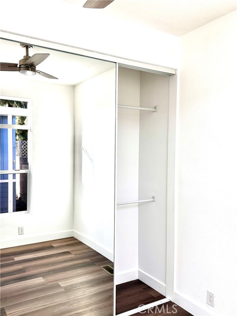 Bedroom Showing Mirrored Closet and Ceiling Fan