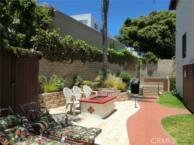 Back Yard with Gazebo, Fire Table & Grill, Stone Flooring and Retaining Wall