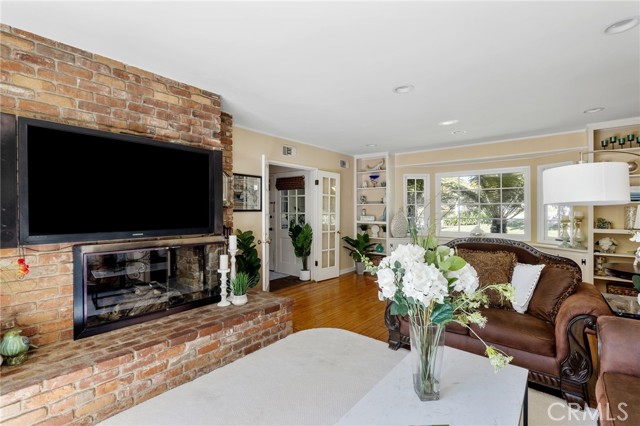 Two-sided fireplace with exposed brick and big, raised hearth.  Surround sound in this room, too.