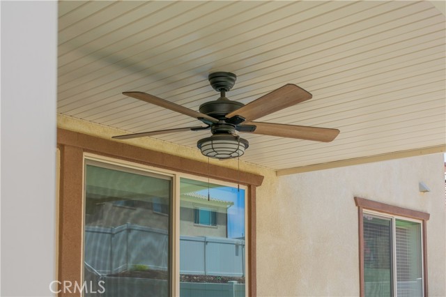 ceiling fan under patio with light