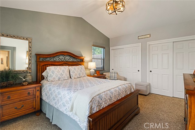 Primary suite with vaulted ceiling, newer light/fan fixture and double closets.