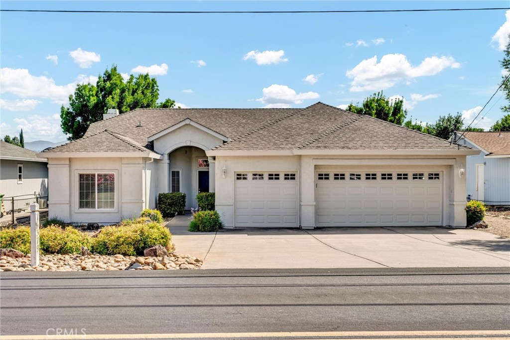 Situated on the 3rd Fairway at Hidden Valley Lake's Championship Golf Course, this 3 bed / 2 bath single level home offers 1,807 SF of spacious living space. Beautiful stucco home with new exterior paint and low maintenance landscaping will catch your eye from the road. Large level driveway with plenty of room for parking + a 3 car garage for your vehicles, golf cart or storage! The tiled entry leads to the spacious living room with vaulted ceilings and new vinyl plank flooring. Stately propane fireplace with brick hearth is a nice focal point in the space. The kitchen is open to the living room with a center island, tiled countertops and loads of storage cabinetry. Dine at the breakfast bar, dining nook or formal dining room off the entry. Desirable separation floorplan with 2 guest bedrooms & bathroom on one end with primary and full laundry room with utility sink on the other. Access the back patio from the living room or the primary bedroom. The views from the covered patio of lush green grass year round with surrounding hills in the distance will never get old! Up for some competition? A custom 9 hole putting green with fringe for chipping or the built-in horseshoe pit provides endless outdoor entertainment! The primary bedroom has plush carpet, a ceiling fan and an ensuite bathroom with large walk-in closet + built-ins, new vinyl plank flooring, large walk-in shower, soaking tub and dual sink vanity. This well maintained home shows pride of ownership, add it to your list today!