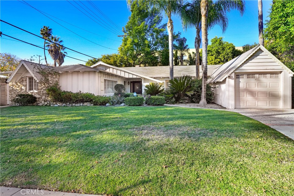 This beautiful, mid-century modern home designed by famed architect, Charles Du Bois, located on a picturesque tree-lined street in the coveted Woodland West neighborhood. Boasting 2,483 sq ft of living space with 4 bd/3ba and sits on an 8,341 sq ft lot. Upon entry, you’ll be greeted with recessed lighting and luxurious travertine flooring throughout. The kitchen boasts stainless steel appliances, recessed lighting, granite countertops and a breakfast bar. You’ll be captivated by the vaulted post and beam ceilings and dual hearth fireplace that is shared by the family room and living room. Both rooms have a natural warmth with ample amounts of light coming through the dual sliding glass doors. You have many options to retreat into the backyard for fun and relaxation in or around the pool which is equipped with a newer pool heater. The large primary is ensuite and includes direct access to the patio. The garage was converted and can be used as a second primary or a bonus room, complete with a bathroom, laundry room and a tankless water heater. This home also has copper plumbing as well as a one car garage. Not only is the home and neighborhood amazing, but it is also centrally located to the Commons at Calabasas, award-winning schools, shopping, and dining. Take a short drive through Topanga Canyon to have access to the beach or head the other way and reach the Village at Topanga, the Westfield Topanga mall and Costco making all your needs readily available. Seize the opportunity to make this wonderful location a home!