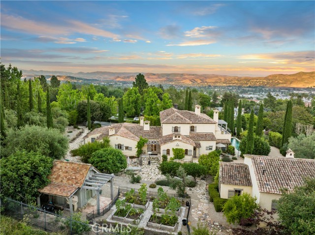 Authentic Provencal gated estate in San Juan Capistrano, with world-class beaches, shopping and dining nearby (but seemingly a world) away. This exquisite private estate is approximately 1-acre of paradise with views of the hillsides, canyons, and peek-a-boo ocean views. The architect/builder used French artifacts, antique components, and artisan finishes imported from France throughout the main residence and guest house, every detail has been selected for its beauty, authenticity and rich patina. There are 5 large stone fireplaces in the main house, which features a formal living room and dining room, climate controlled wine room, gourmet kitchen with family room, an office, 4 bedrooms, and 6 bathrooms. The home has beautiful limestone and wood flooring throughout. The gardens surrounding the home are beautifully landscaped in Provencal style with fruit trees and plantings. The outdoor area has a salt water lap pool, fountain and built-in BBQ. In addition the guest house has 1 bedroom and bathroom, kitchen, family room and office. A separate garden house with 1/2 bath sits amid vegetable and herb beds. The result is an estate with a sense of history and relaxed elegance formerly reserved for centuries-old European country manors. Close to the prestigious school  St. Margaret's Episcopal and J Serra.