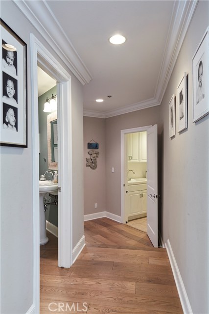 Hallway to powder room, downstairs bedroom and laundry room