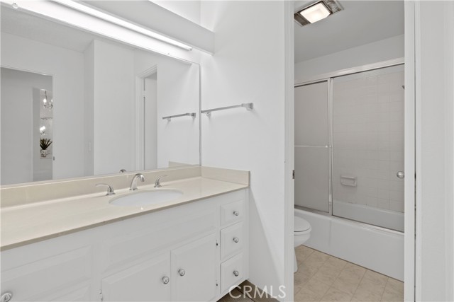 Hallway full bathroom with spacious vanity and counter space with separate room for tub/shower.