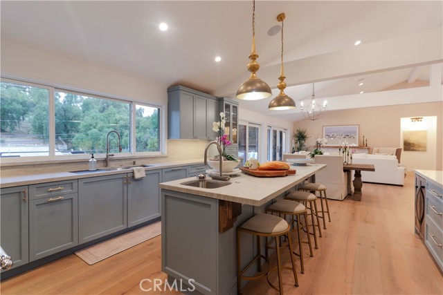 This open, family-style kitchen has it all! The prep sink with a waterfall vegetable wash, pull-down sprayer and built-in glass rinse for beverage and wine glasses makes entertaining and daily life a breeze!