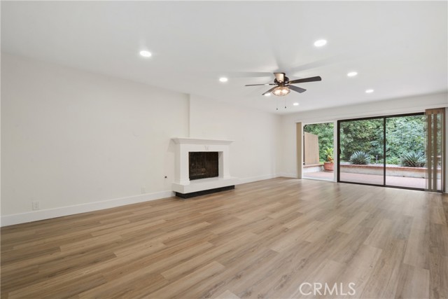 Spacious living room with recessed lighting, recently remodeled fireplace, newer laminate flooring and new verticle blinds. This great room opens to a tranquil backyard patio with peaceful tree views. A great place to relax with your morning coffee and newspaper or tablet.