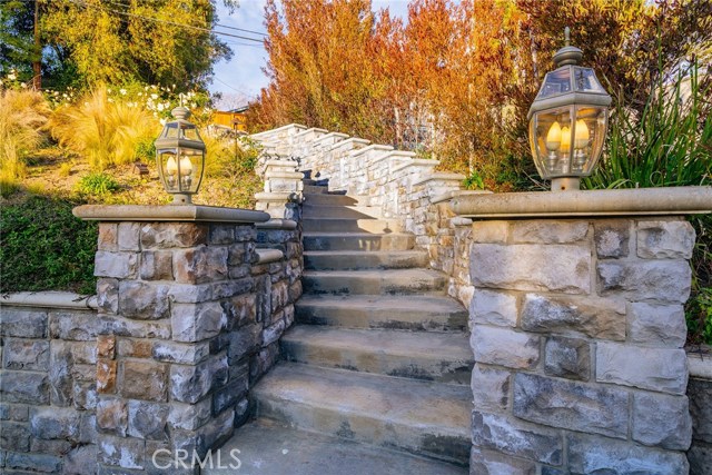 Winding stairs lead you through beautiful landscaping to the upper level yard.