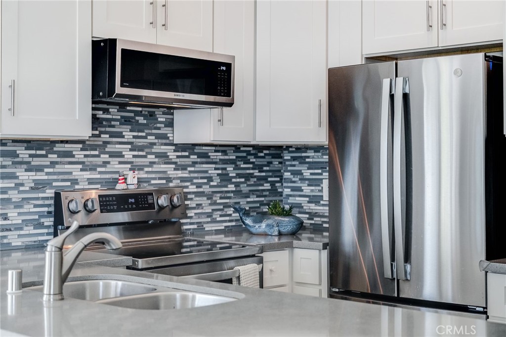 Welcome to 23 Brighton Place — a beautifully upgraded, private corner unit nestled just minutes from the beach. Perched on the top floor, this light-filled home offers rare privacy and serene views with no neighbors above.

Step inside to a designer-upgraded kitchen featuring quartz countertops, custom cabinetry, and stainless steel appliances, perfect for cooking and entertaining. The bathroom has been thoughtfully remodeled with premium finishes, creating a spa-like atmosphere.

Enjoy resort-style living with access to three pools, spas, tennis courts, a clubhouse, fitness center, and scenic walking trails. With easy access to the best of Laguna Niguel and Dana Point — from shops and dining to world-class beaches — this is coastal Southern California living at its finest.