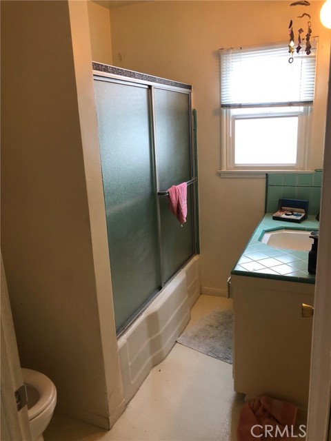 Bathroom off hallway in back