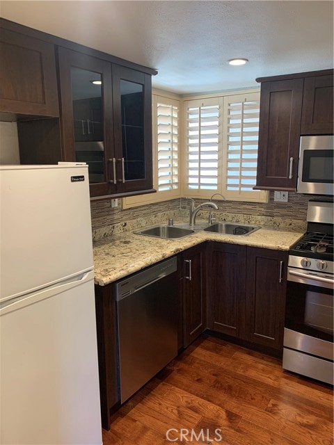 Corner Kitchen sink, window has wood shutters