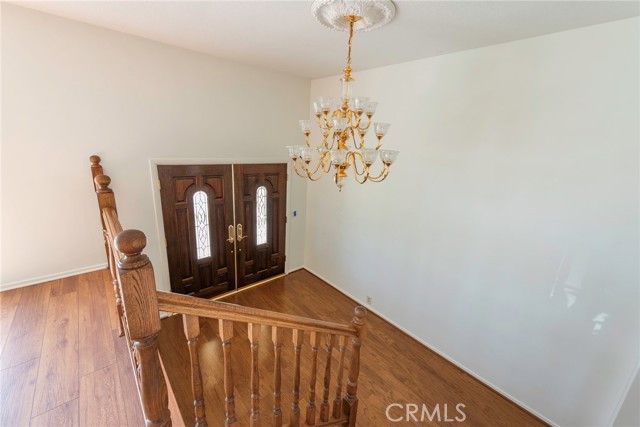 Looking down on entryway from living room stairway